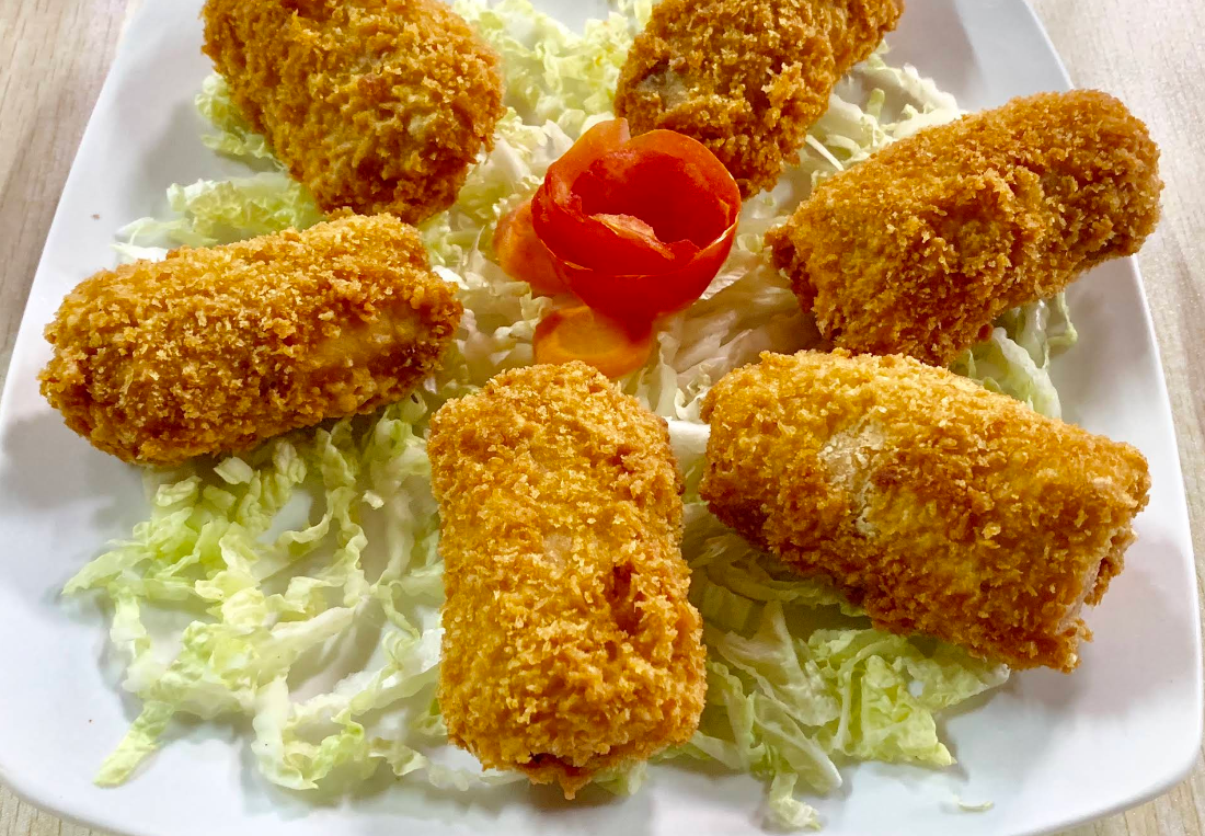 Breaded seafood rolls on lettuce